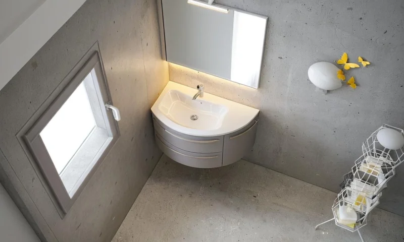 Arredo bagno moderno compatto con base curva e piano Top Jolly in Mineralguss.
